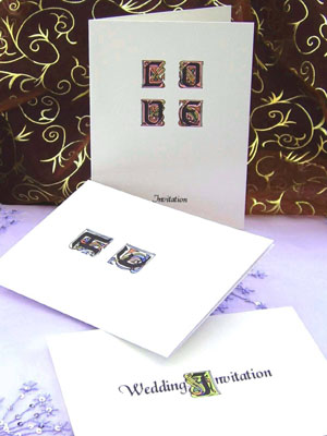 Wedding invitations decorated with illuminated letters.